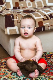 10 Month Child Sitting With Toy And Looking Ahead Stock Photos