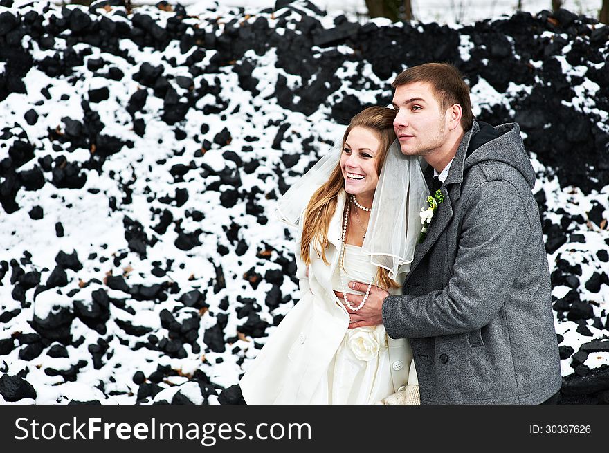 Happy bride and groom in winter day on their wedding