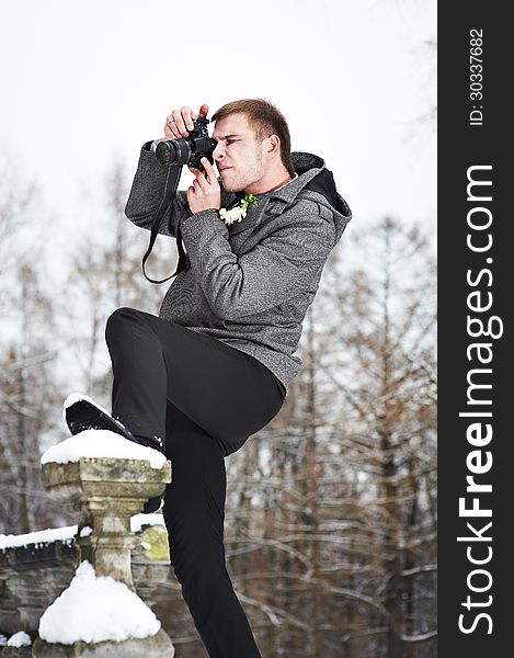 Young Man With A Camera At Winter