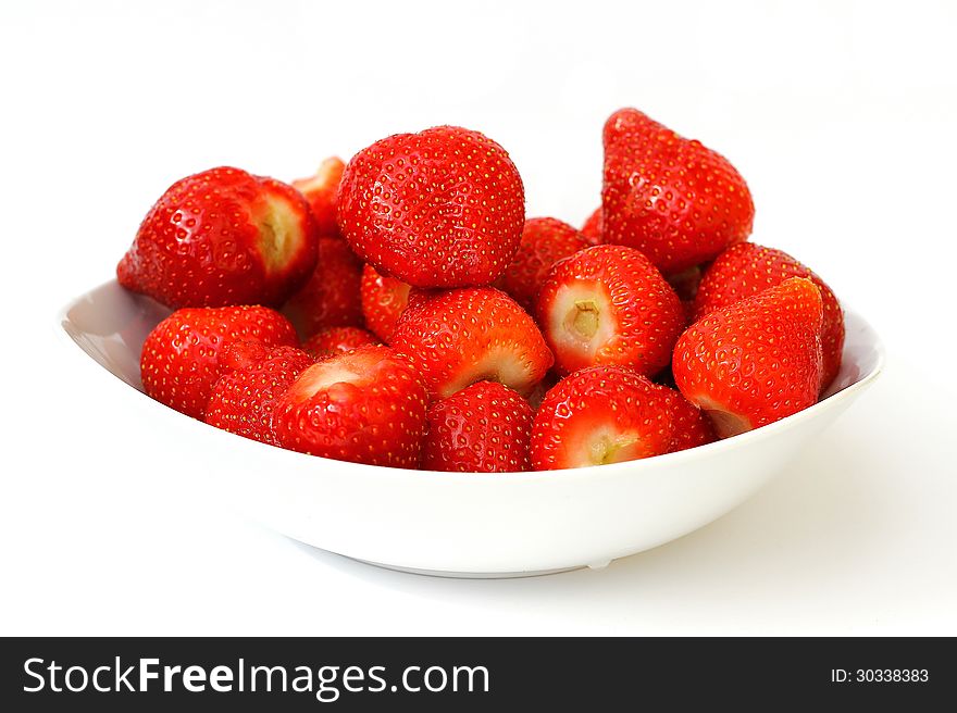 Fresh strawberries in a bowl on white background