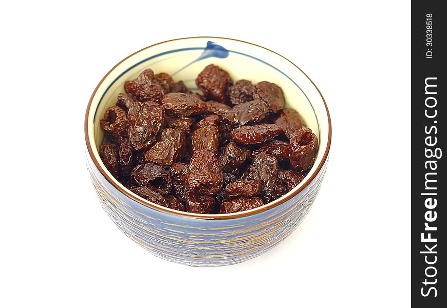 Dried olives in a bowl on a white background