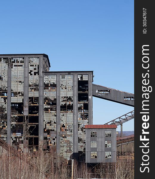 Abandoned coal breaker with busted windows and stripped interior in northeast Pennsylvania. Abandoned coal breaker with busted windows and stripped interior in northeast Pennsylvania.