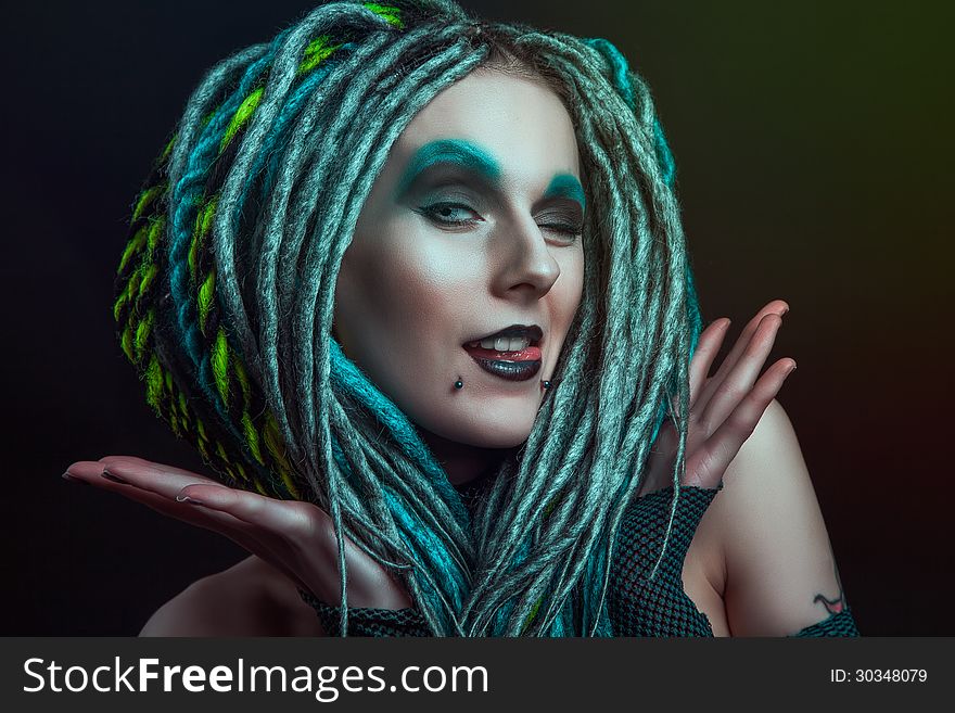 Pretty girl with dreadlocks posing in studio. Pretty girl with dreadlocks posing in studio