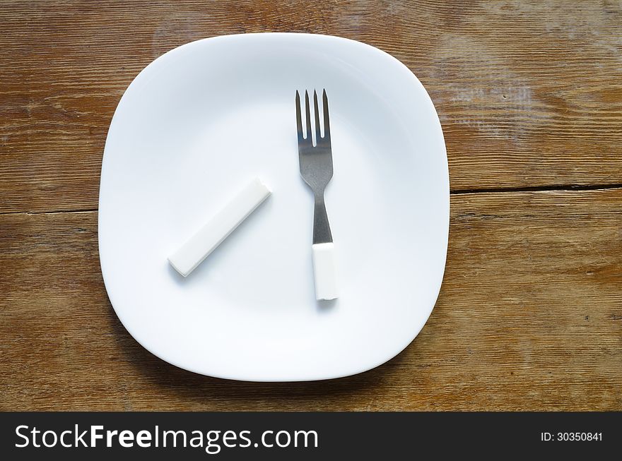 White plate with broken fork on it