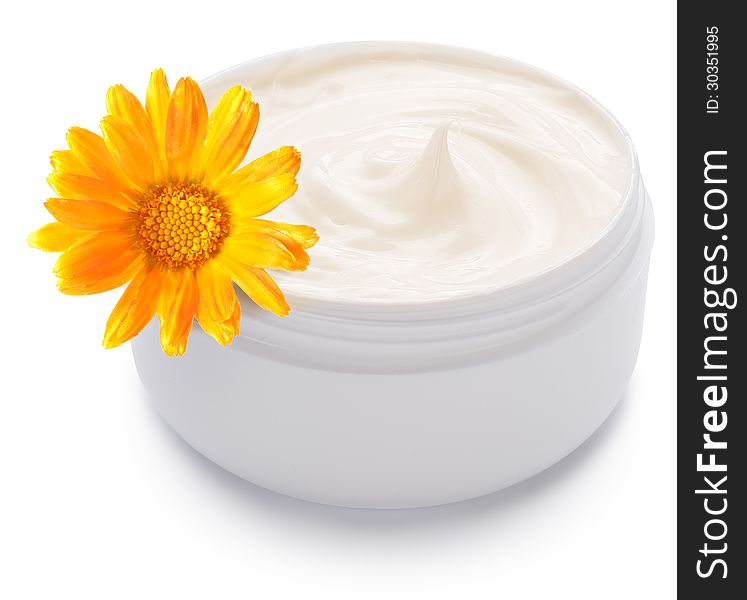 Jar of cream and calendula flower on a white background. Jar of cream and calendula flower on a white background.