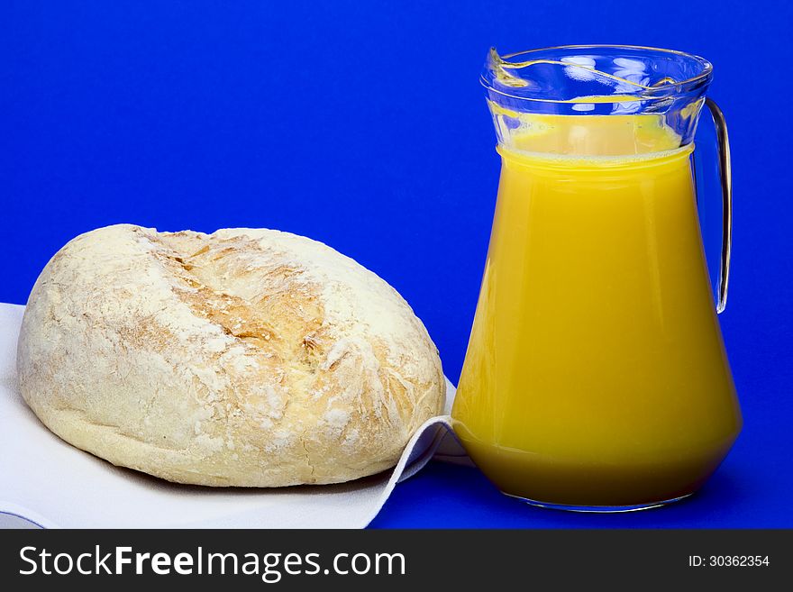 White homemade bread and a jug with orange juice. White homemade bread and a jug with orange juice