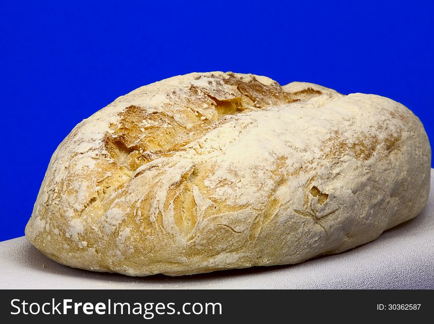 Home-baked bread on a blue background. Home-baked bread on a blue background
