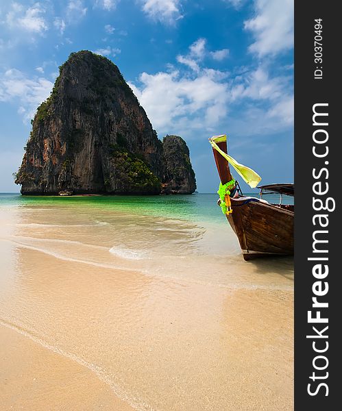 Tropical beach landscape. Thai traditional long tail boats at ocean gulf under blue sky. Pranang cave beach, Railay, Krabi, Thailand