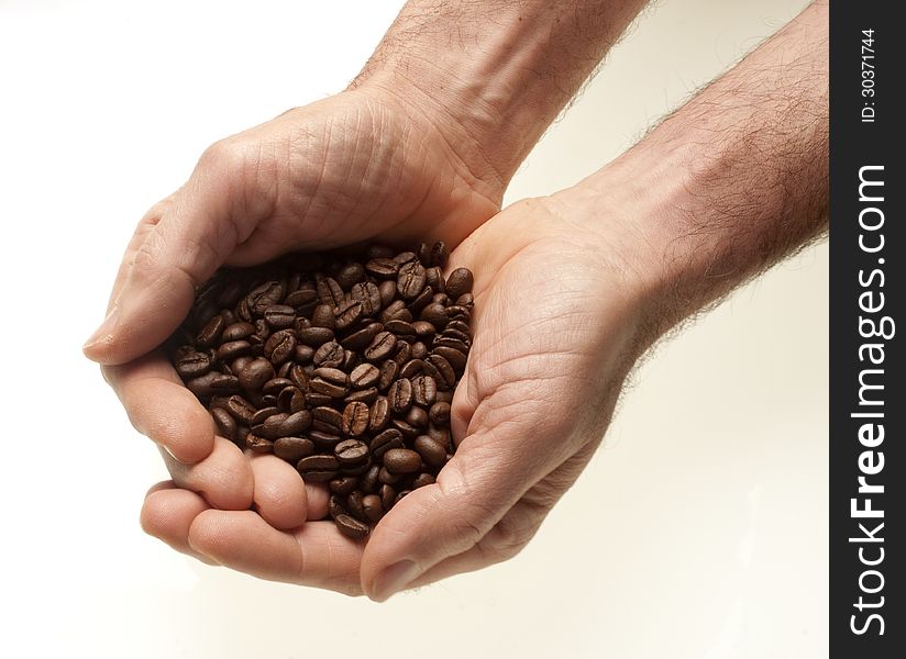 Two caucasian male hands with coffee beans. Two caucasian male hands with coffee beans