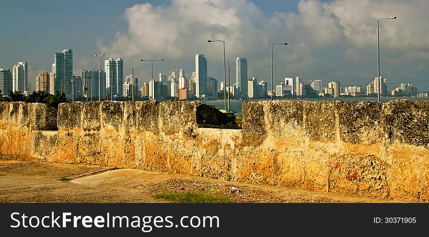 Contrast: High rising towers of Cartagena´s touristic peninsula Bocagrande seen from the old City Wall (XVI Century). Contrast: High rising towers of Cartagena´s touristic peninsula Bocagrande seen from the old City Wall (XVI Century).