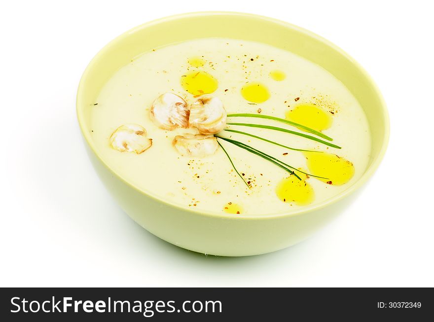 Mushroom Creamy Soup with Champignon and Greens in Yellow Bowl on white background