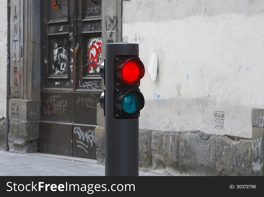 Traffic light in red on degraded old street. Traffic light in red on degraded old street