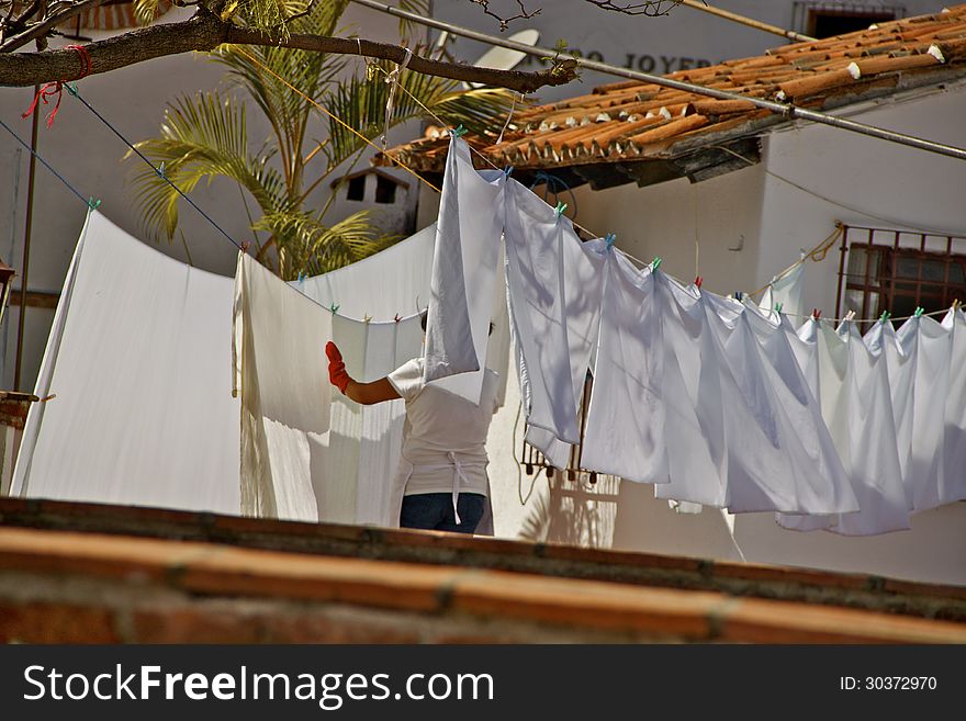 White laundry drying on clothesline on a hotelÂ´s rooftop. White laundry drying on clothesline on a hotelÂ´s rooftop