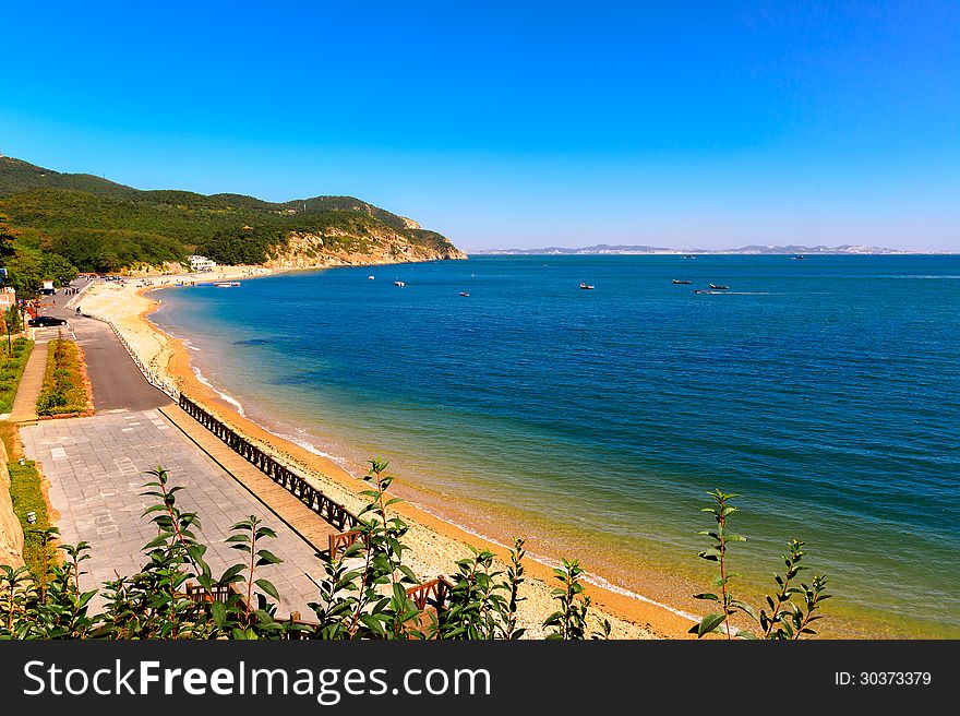 Dalian City, Liaoning Province, China.Wooden club island beach,blue sky,blue sea and golden sand.