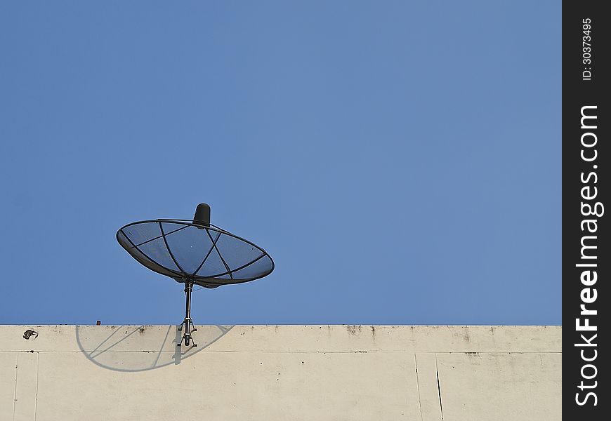 Satellite dish fix on top of building in sunlight. Satellite dish fix on top of building in sunlight