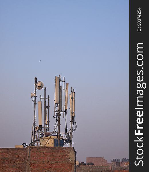 Set of antenna on top roof in sunlight