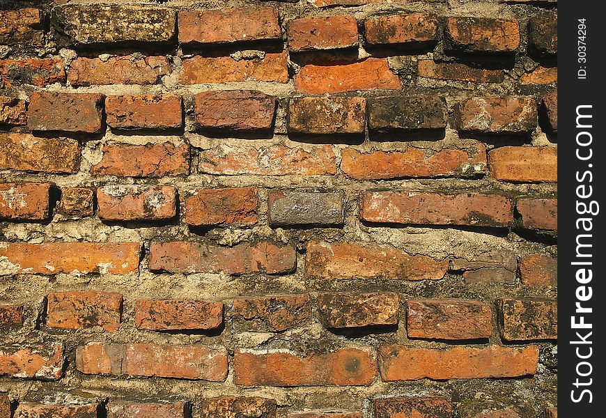 Pattern of old brick wall in sunlight
