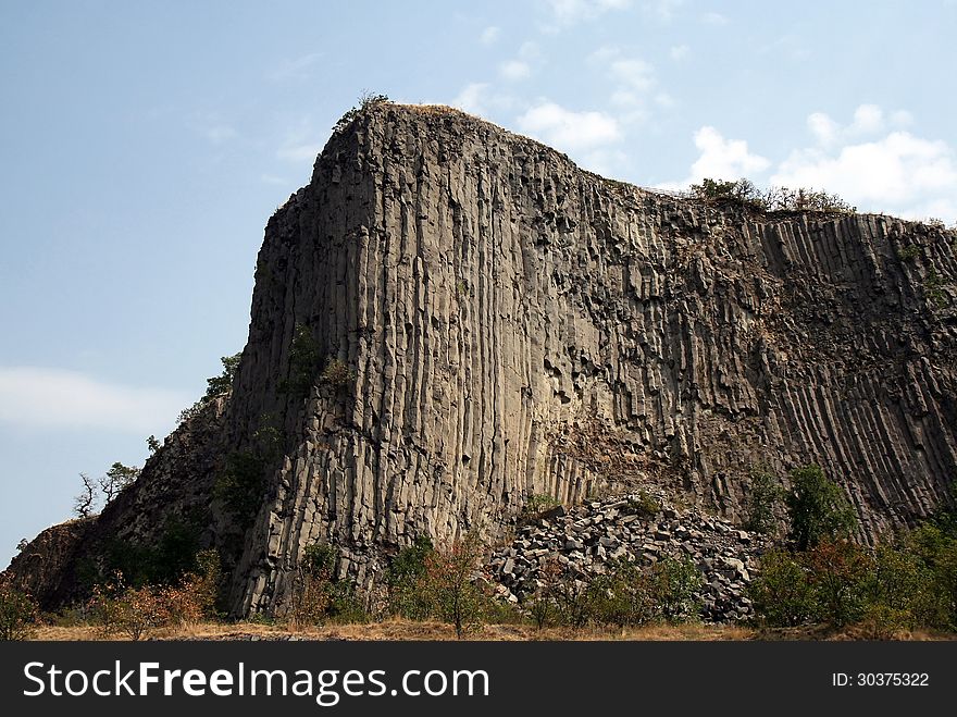 Geological stone hill with basaltic petagonal columns. Geological stone hill with basaltic petagonal columns