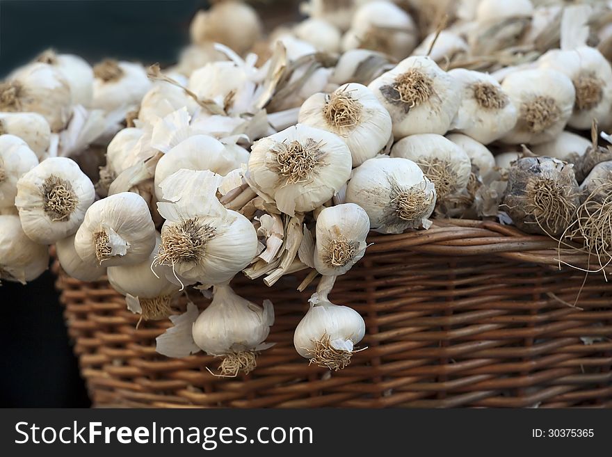 Close up of garlic on a market in a basket. Close up of garlic on a market in a basket