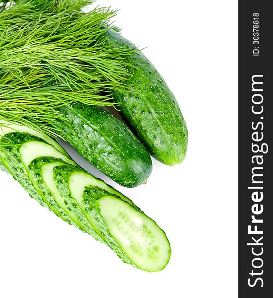 Slices of cucumber is with two cucumber and dill on a white background