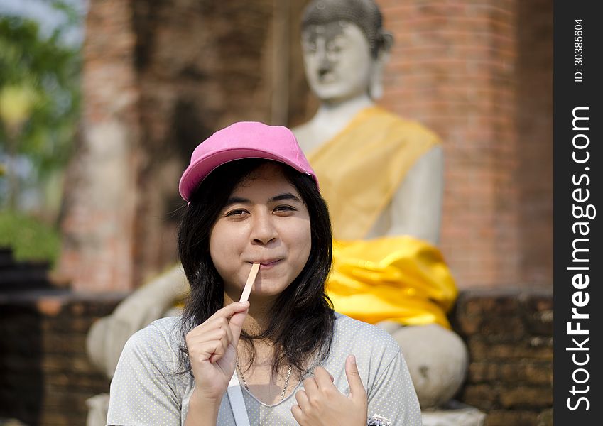 Beautiful young girl and buddha at Wat Yai Chai Mongkol Temple