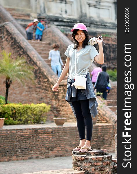Asian woman enjoying at Buddhist temple in Thailand.
