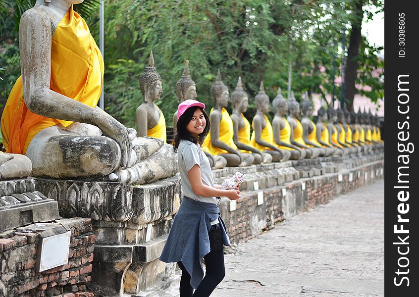 Beautiful Asian Woman And Buddha At Wat Yai Chai Mongkol Temple