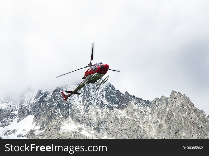 A helicopter working in the italien Alps