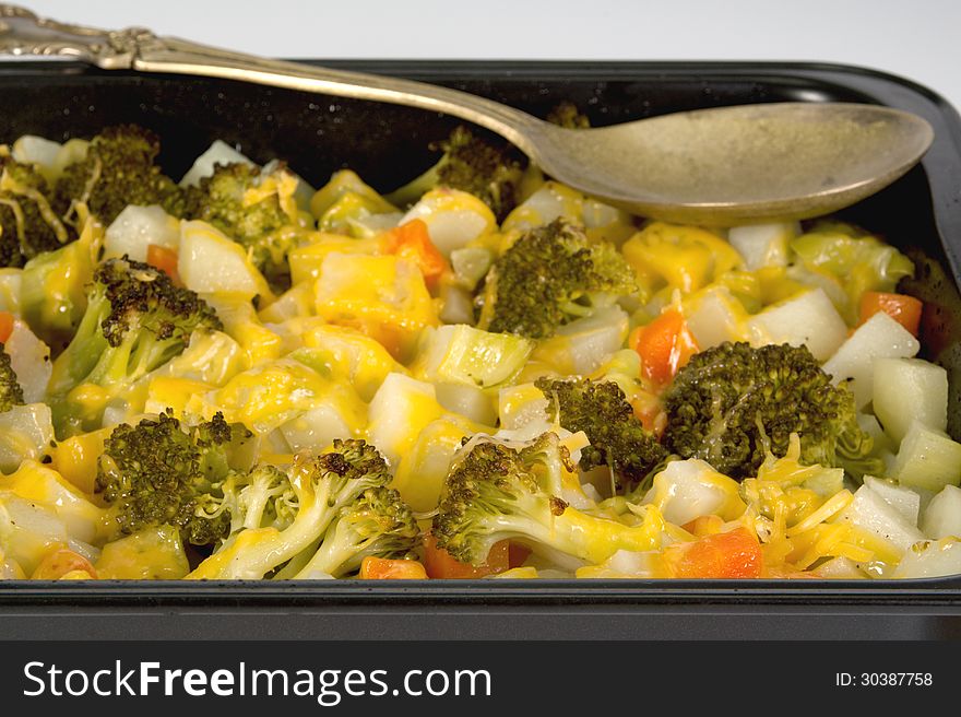 Vegetable gratin in a black baking tray