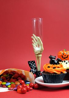 Halloween Cupcakes, Skeleton Glass And Candy Treats On Red Background - Vertical. Stock Images