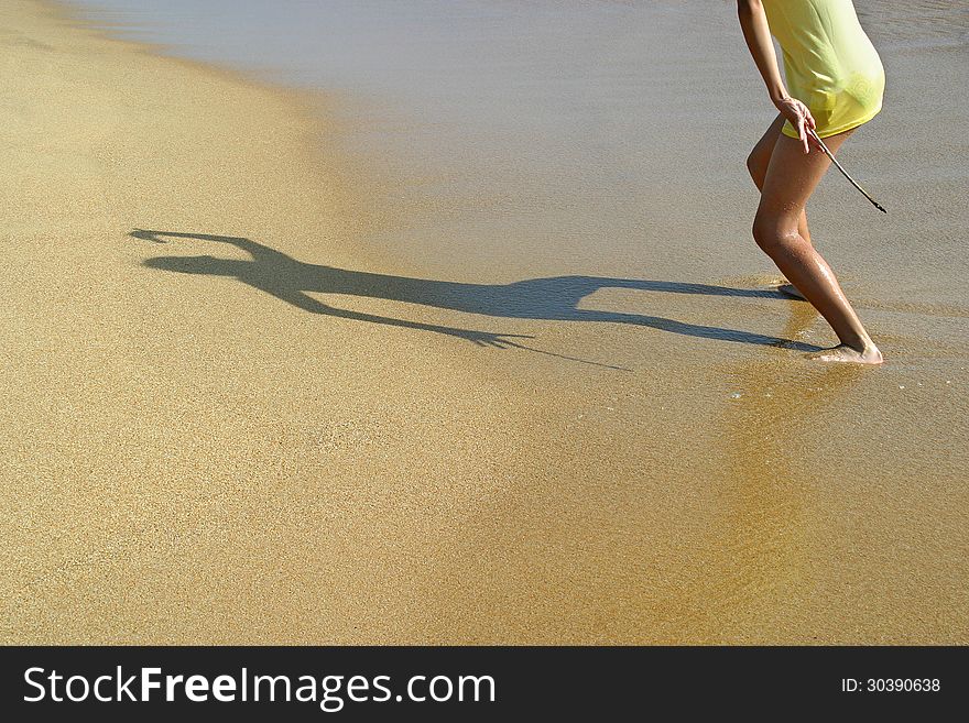 Shadow of the Child on the wet sand of the sea beach. Shadow of the Child on the wet sand of the sea beach