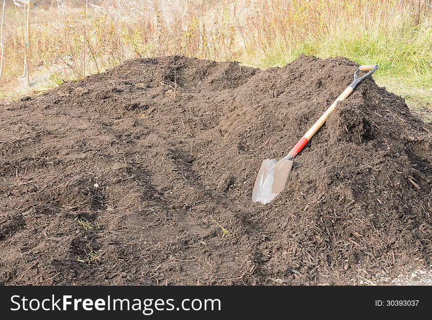 Pile of organic compost with shovel