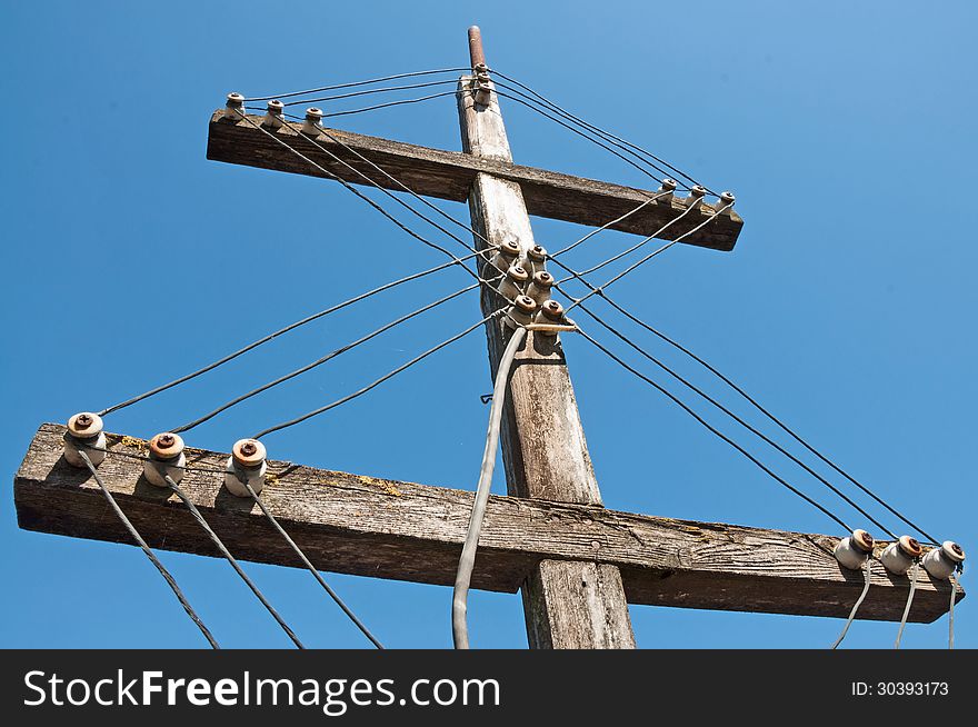 The old TV antenna on blue sky background