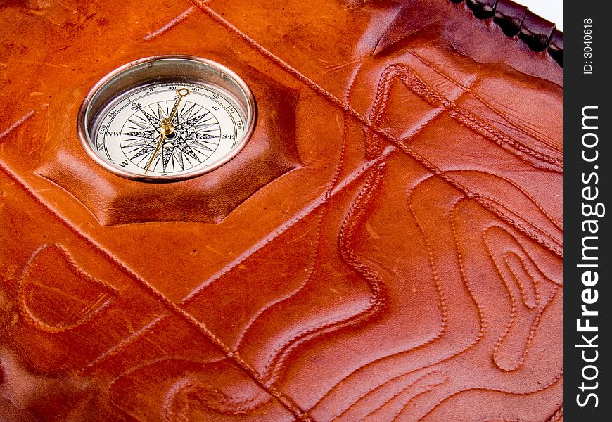 Vintage compass on the leather texture