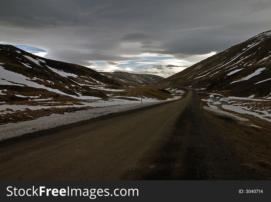 Deserted country road leading into the horizon