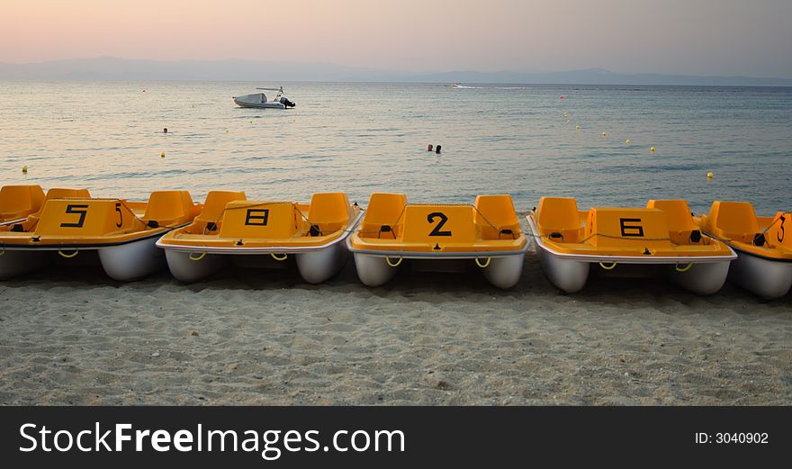 Paddle boats on the beach in the evening