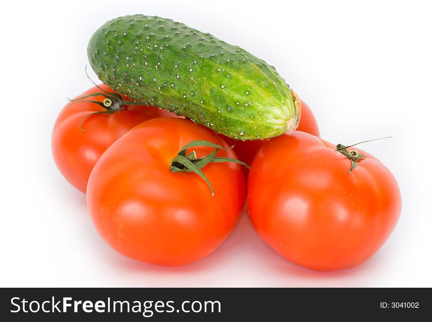 Tomatoes and cucumbers on a white isolated background