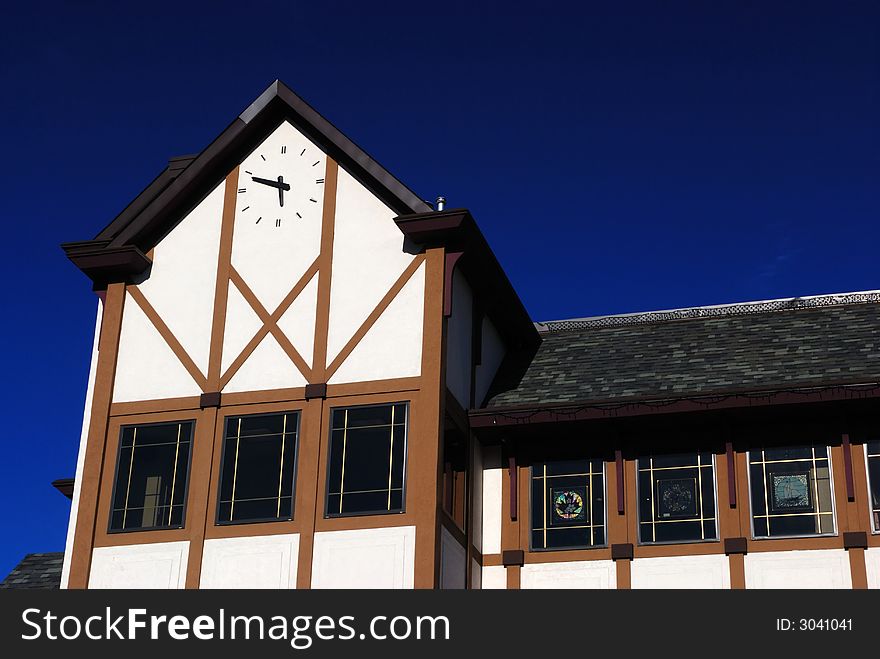 School building with clock, blue sky background