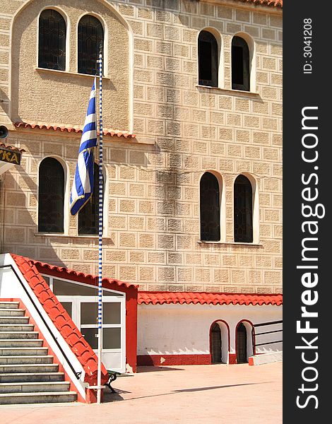 Orthodox church in Greece with a greek flag