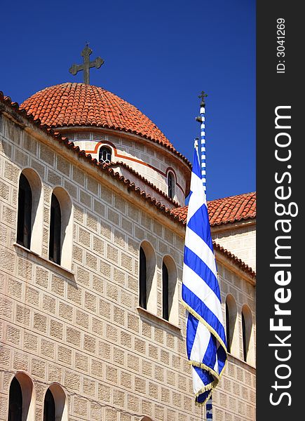 Orthodox church in Greece with a greek flag