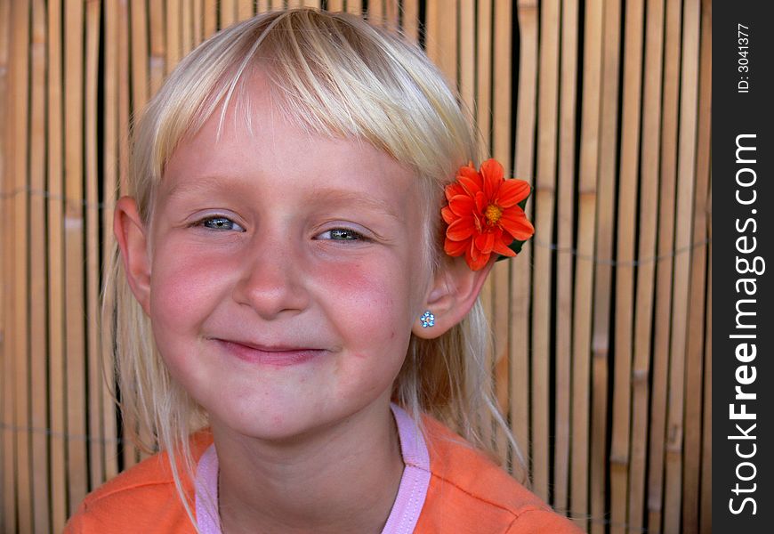 child with flower behind ear.