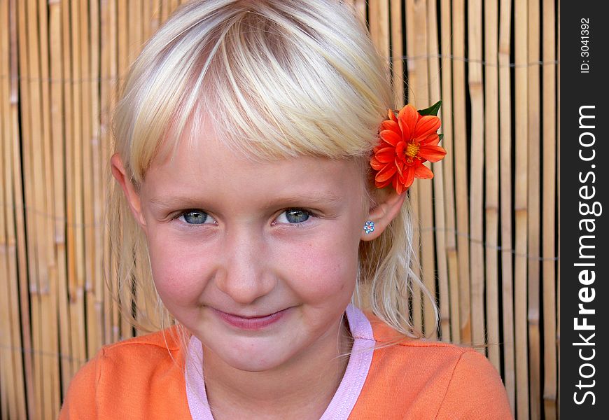 child with flower behind ear