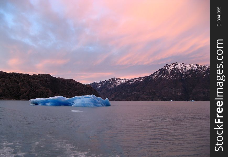 Floating iceberg in Argentina Lake at sunrise