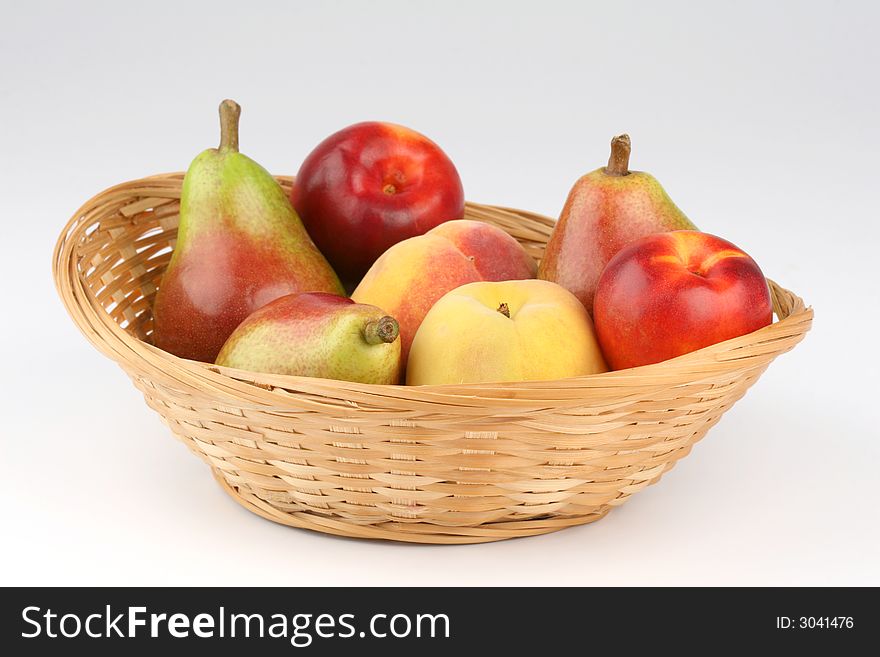 Basket of mixed fruits on the white background