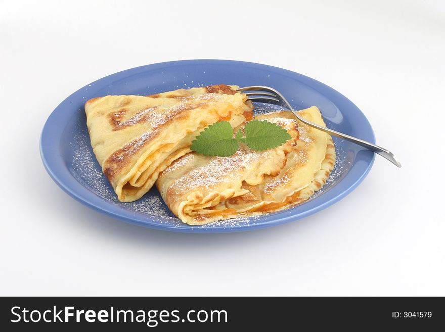 Fresh pancakes on blue plate