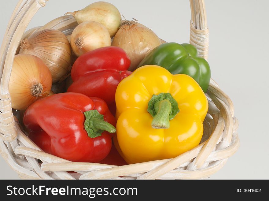 Basket with fresh pepprs and onions. Basket with fresh pepprs and onions