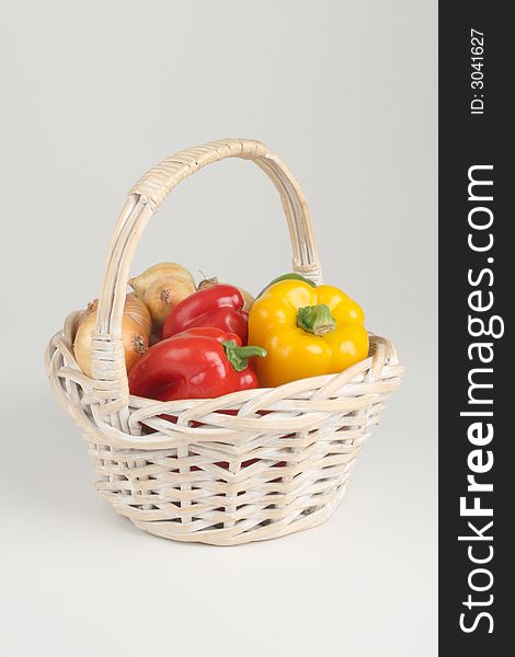 Basket with fresh pepprs and onions. Basket with fresh pepprs and onions