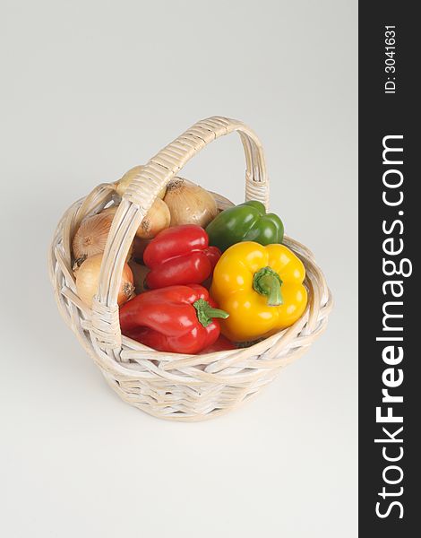 Basket with fresh peppers and onions. Basket with fresh peppers and onions