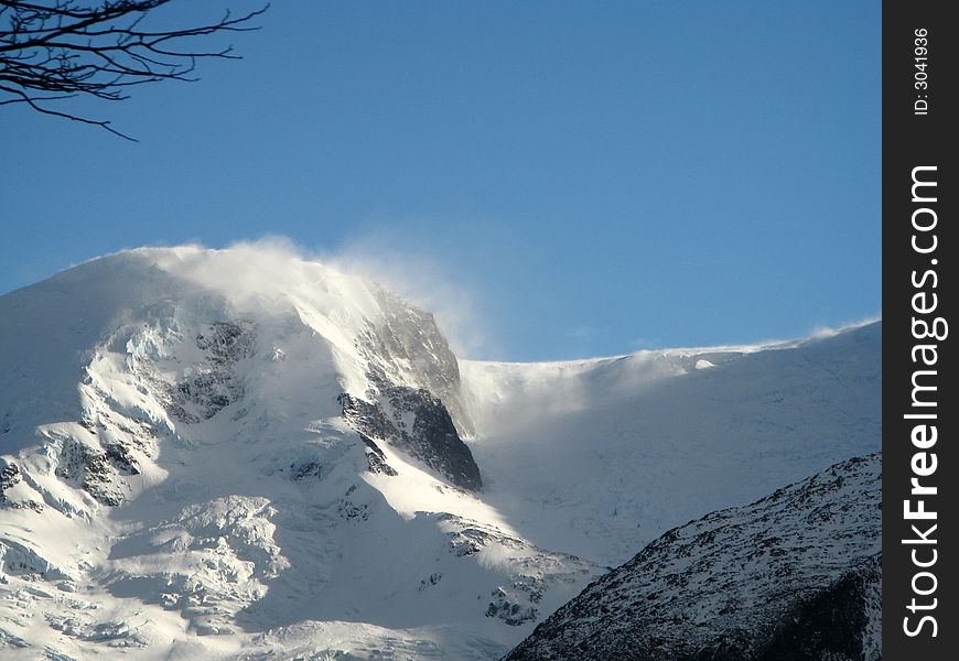 Snow blowing off a mountain top by strong winter winds in Argentina