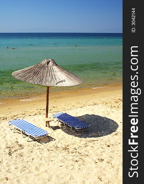 Beach with umbrellas in the morning in Greece